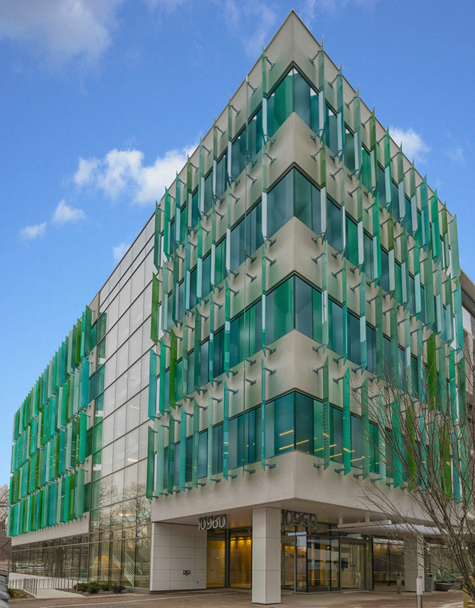 Modern building with green glass panels.