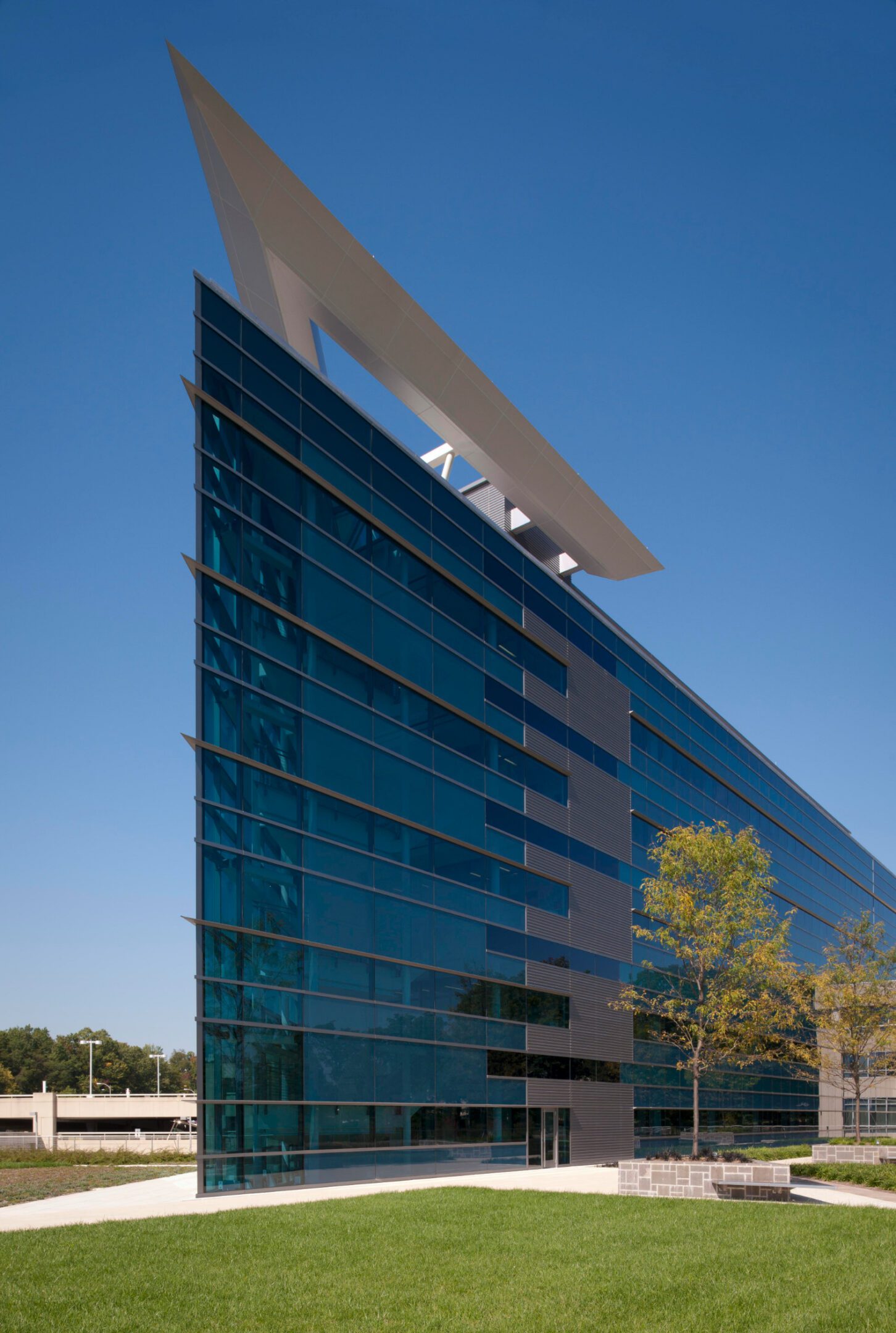 Modern glass building with unique architectural design.