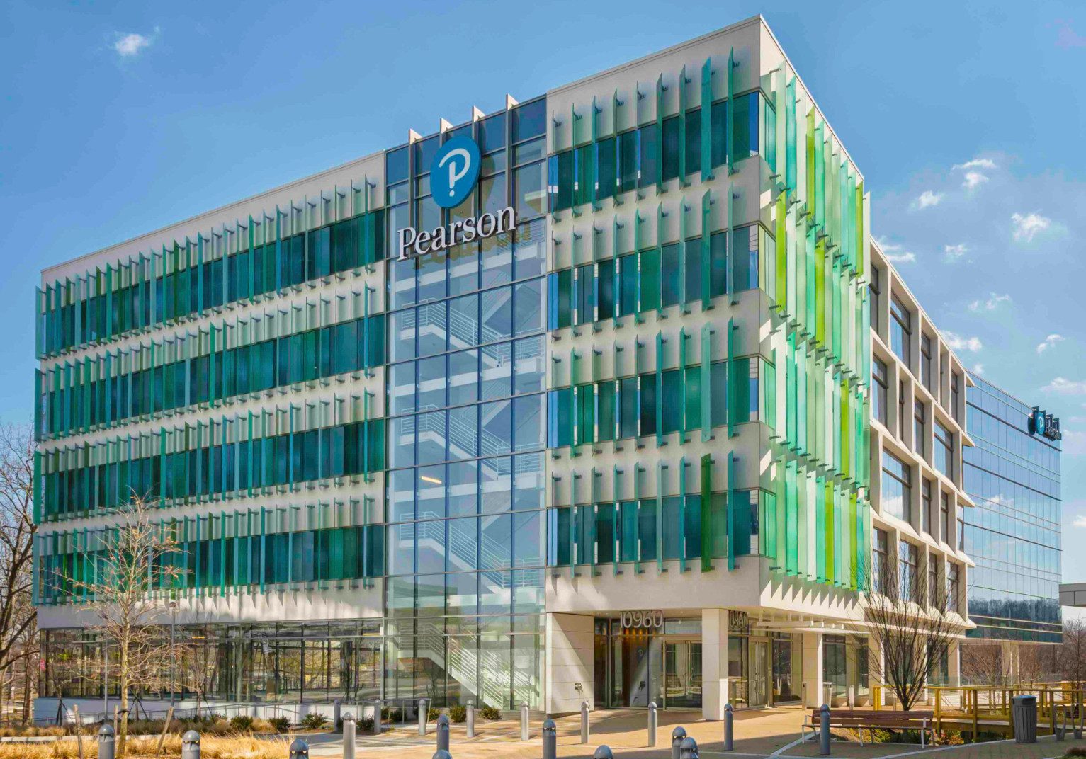 Modern glass office building with green accents